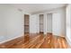 Bright bedroom boasts hardwood floors, large window, and plenty of closet space at 7404 Countrybrook Dr, Indianapolis, IN 46260
