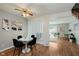 Bright dining room featuring hardwood floors and a contemporary glass table set at 7404 Countrybrook Dr, Indianapolis, IN 46260