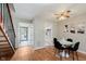Bright dining room with hardwood floors, adjacent to the staircase and kitchen at 7404 Countrybrook Dr, Indianapolis, IN 46260