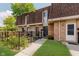 Charming townhome featuring a brick facade, well-maintained landscaping, and a cozy, inviting entrance at 7404 Countrybrook Dr, Indianapolis, IN 46260