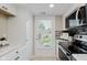 Well-lit kitchen with modern stainless steel appliances and tiled floors at 7404 Countrybrook Dr, Indianapolis, IN 46260