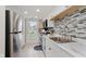Updated kitchen boasts stainless steel appliances and stylish backsplash at 7404 Countrybrook Dr, Indianapolis, IN 46260