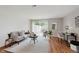 Comfortable living room featuring hardwood floors, neutral tones, and sliding glass doors at 7404 Countrybrook Dr, Indianapolis, IN 46260