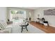 Bright living room features a glass door to the outside and neutral tones at 7404 Countrybrook Dr, Indianapolis, IN 46260
