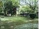 Expansive backyard with mature trees and a meticulously maintained lawn, offering a serene outdoor space at 8728 Holliday Dr, Indianapolis, IN 46260