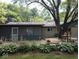 Outdoor patio with a screen door and mature landscaping at 8728 Holliday Dr, Indianapolis, IN 46260