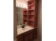 Bathroom vanity featuring storage shelving, a white countertop, and a mirror at 8728 Holliday Dr, Indianapolis, IN 46260