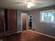 Bedroom with closet, window, and entry to ensuite featuring hardwood floors at 8728 Holliday Dr, Indianapolis, IN 46260