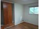 Bedroom featuring hardwood floors, closet with sliding doors, and natural light from window at 8728 Holliday Dr, Indianapolis, IN 46260