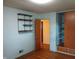 Bedroom with built-in wardrobe, shelving, light-colored walls, and hardwood floors at 8728 Holliday Dr, Indianapolis, IN 46260