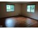 Bedroom featuring hardwood floors and two windows offering ample natural light and exterior views at 8728 Holliday Dr, Indianapolis, IN 46260