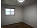 Simple bedroom with hardwood floors and a window providing natural light at 8728 Holliday Dr, Indianapolis, IN 46260