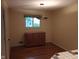Dining area with hardwood floors, a window, and custom cabinet providing storage and charm at 8728 Holliday Dr, Indianapolis, IN 46260