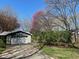 Attached garage with a paved driveway and manicured landscaping at 8728 Holliday Dr, Indianapolis, IN 46260