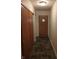 Hallway featuring unique tile flooring, closet, and front door with window at 8728 Holliday Dr, Indianapolis, IN 46260