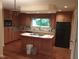 Updated kitchen featuring wood cabinets, modern appliances, breakfast bar, and ample counter space at 8728 Holliday Dr, Indianapolis, IN 46260