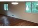 Living room showcasing hardwood floors, natural light from windows and neutral wall color at 8728 Holliday Dr, Indianapolis, IN 46260