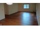 Spacious living room featuring gleaming hardwood floors and a window for natural light at 8728 Holliday Dr, Indianapolis, IN 46260