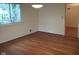 Inviting living room with hardwood flooring, window views, and convenient access to other areas of the home at 8728 Holliday Dr, Indianapolis, IN 46260