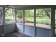 Screened in porch with views of the tree lined backyard at 8728 Holliday Dr, Indianapolis, IN 46260