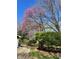 Landscaped side yard with flowering trees and lush green bushes at 8728 Holliday Dr, Indianapolis, IN 46260