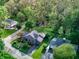 Aerial view showcasing a beautifully landscaped property with mature trees, gray home, and well-manicured lawn at 901 Center Dr, Noblesville, IN 46060