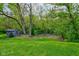 Large backyard features a small storage building with green lawn surrounded by mature trees, offering privacy at 901 Center Dr, Noblesville, IN 46060