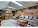Spacious finished basement with wood-paneled walls, a bar, and comfortable seating area at 901 Center Dr, Noblesville, IN 46060