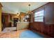 Open-concept kitchen dining area with a decorative light fixture and ample counter space at 901 Center Dr, Noblesville, IN 46060
