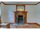 Close-up of the fireplace with a decorative mantel, brick surround, and protective screen at 901 Center Dr, Noblesville, IN 46060