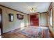 Bright living room with hardwood floors, built-in cabinet, vintage mirror and an area rug at 901 Center Dr, Noblesville, IN 46060