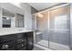 This bathroom has a gray tile shower with a bench, a window, and a vanity with a white countertop at 9422 Oakley Dr, Indianapolis, IN 46260