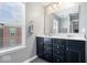 A view of the bathroom, which offers a double sink and a window for natural light at 9422 Oakley Dr, Indianapolis, IN 46260