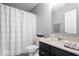 Bathroom featuring a shower and tub combo, a white patterned shower curtain, and a dark vanity at 9422 Oakley Dr, Indianapolis, IN 46260