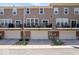 Rear exterior view of townhomes with private balconies and garage access at 9422 Oakley Dr, Indianapolis, IN 46260