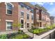 Beautiful brick townhomes with manicured landscaping and inviting entrances, offering a stylish living experience at 9422 Oakley Dr, Indianapolis, IN 46260