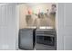 Convenient laundry area featuring modern washer and dryer units and shelving at 9422 Oakley Dr, Indianapolis, IN 46260