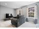 An additional sitting area with a TV and a comfortable chair near a window at 9422 Oakley Dr, Indianapolis, IN 46260