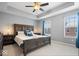 This main bedroom features a tray ceiling, a ceiling fan, and plenty of natural light at 9422 Oakley Dr, Indianapolis, IN 46260