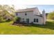 Back exterior view of a two-story home with a sliding glass door leading to a wooden deck and green lawn at 950 Hearthside Dr, Brownsburg, IN 46112