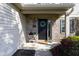 Inviting front entrance with a decorative wreath, brick accents, and well-manicured landscaping at 950 Hearthside Dr, Brownsburg, IN 46112