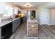 Modern kitchen featuring granite countertops, stainless steel appliances, and a breakfast bar at 950 Hearthside Dr, Brownsburg, IN 46112