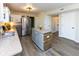 Well-lit kitchen featuring stainless steel appliances and a center island, perfect for cooking and entertaining at 950 Hearthside Dr, Brownsburg, IN 46112