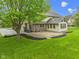 The backyard features a brick patio, lush lawn, mature shade trees and professional landscaping at 960 Arrowwood Dr, Carmel, IN 46033