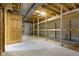 Unfinished basement with built in wooden storage shelving and an open door at 960 Arrowwood Dr, Carmel, IN 46033