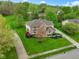 Aerial view of a beautiful brick two story home with a large well-manicured lawn at 960 Arrowwood Dr, Carmel, IN 46033