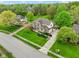 Aerial view of a beautiful brick two story home with a large well-manicured lawn at 960 Arrowwood Dr, Carmel, IN 46033