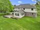 The backyard features a brick patio, sunroom addition, lush lawn, and professional landscaping at 960 Arrowwood Dr, Carmel, IN 46033