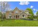 Charming two-story brick home with a well-manicured lawn and inviting red front door at 960 Arrowwood Dr, Carmel, IN 46033