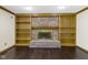 A brick fireplace, flanked by built-in shelving, creates a cozy focal point at 960 Arrowwood Dr, Carmel, IN 46033
